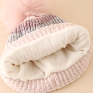 Warm winter knit hat with colorful stripes, pink faux fur pom and thick fleece lining