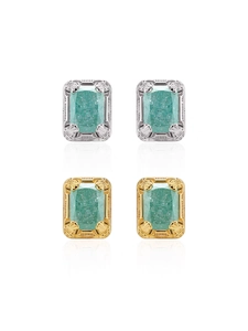 Close-up of vintage 18K gold earrings featuring ice blue rectangular gems and engraved frames