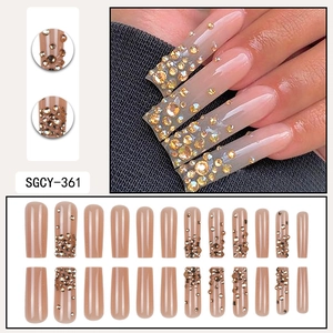 Extra long square press-on nails in nude pink with gradient gold rhinestones set