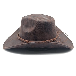 Detail of dark brown faux suede cowboy hat featuring a braided band and upturned brim