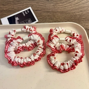 Set of four red and white gingham hair scrunchies with lace trim and heart patterns