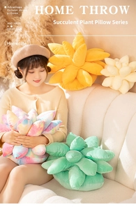 Close-up of colorful succulent plush pillows in pink, green and yellow on a white sofa
