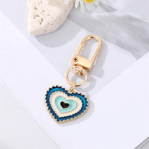 Detailed view of colorful heart-shaped evil eye pendant with golden lobster clasp