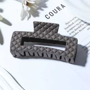 Matte taupe rectangle hair claw clip with quilted texture and hollow design