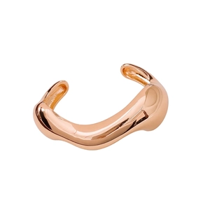 Irregular rose gold open bangle featuring a polished lava-style minimalist design
