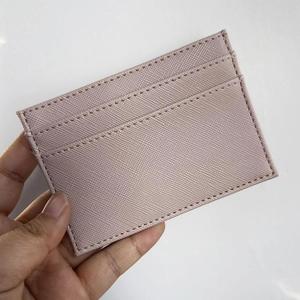 Close-up of pink Saffiano PU leather card holder showing three-tier card slots