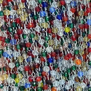 Macro view of multi-color crystal beads with silver wire links for DIY jewelry making
