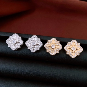 Close-up of geometric flower earrings with zircon pavé in gold and silver plating