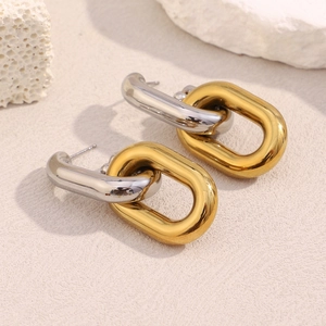 Detailed view of two-tone hollow chain link earrings in 18K gold and silver stainless steel