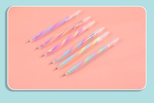 Close-up of 6 rainbow gel pens with spiral texture on a soft pink background