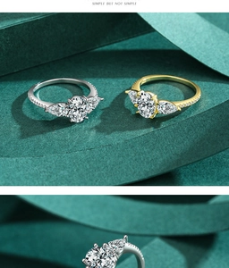 Macro detail of oval cut faux diamond rings in silver and gold finishes with side stones