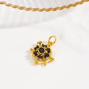 Detail of 18k gold plated turtle pendant with black zircon inlays on back