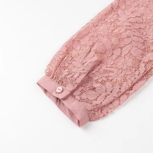 Detail view of lace sleeve with elegant satin cuff on a dusty pink polo shirt