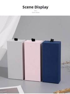 Detail of drawer gift boxes in pink, grey and blue with ribbon pulls and fabric texture