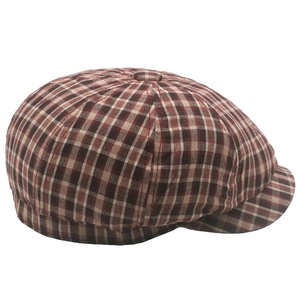 Close-up of red and beige checkered cotton newsboy cap with classic eight-panel structure