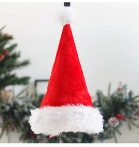 Close-up of soft plush texture and fluffy white ball on a classic red Santa Claus hat