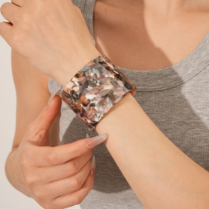 Macro detail of vintage acetate open cuff bracelet with grey marble stone texture