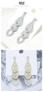 Detailed view of luxury silver-tone tassel earrings with multi-layered crystal rhinestones