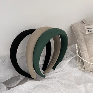 Three minimalist padded fabric headbands in black beige and dark green colors
