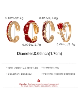 Set of four gold alloy rings featuring rose, star, and G letter detail with sizing data