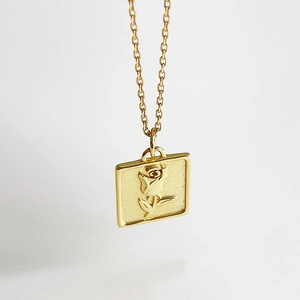 Golden square necklace featuring a detailed rose embossed pendant on a fine link chain