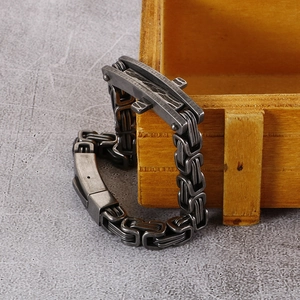 Macro detail of retro steel chain bracelet with industrial gray finish and folding clasp