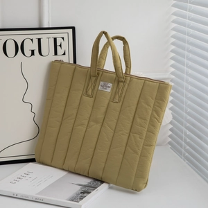 Olive green quilted 11-inch iPad sleeve with carrying handles and metal zipper detail