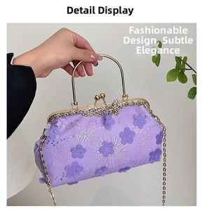 Close-up of purple banquet bag with 3D floral embroidery and gold metal handle
