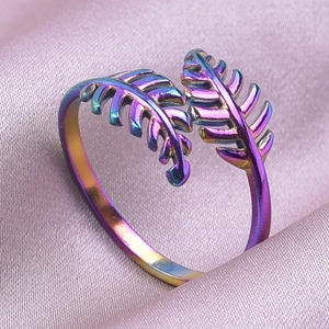 Detail shot of rainbow finish stainless steel leaf ring on soft silk background