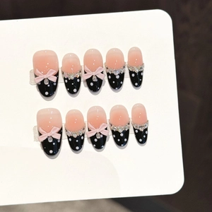 Handmade press-on nails with pink black gradient, polka dots, bows and rhinestones