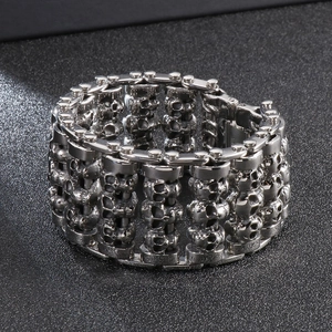 Macro shot of punk style stainless steel skull bracelet with triple-row interlocking links