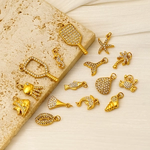 Thirteen gold plated stainless steel marine charms with clear zircon stone inlays
