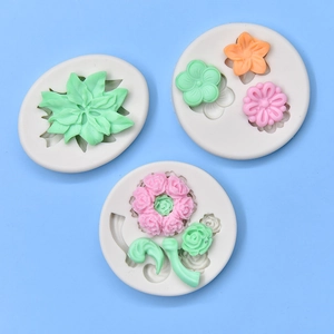 Three assorted flower and leaf silicone fondant molds with colorful finished crafts