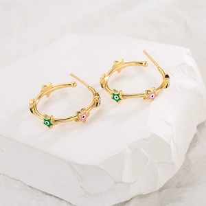 Detailed shot of 18K gold-plated C-shaped hoop earrings with colorful evil eye star charms