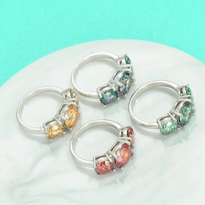 Elegant S925 sterling silver rings set with colorful moissanite stones on marble plate