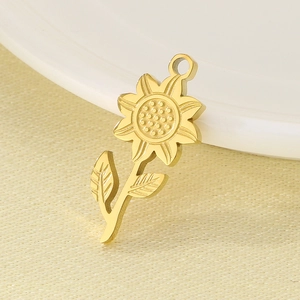 Detailed macro view of a golden sunflower pendant charm made from stainless steel