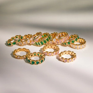 Detailed display of assorted gold-plated rings with colorful zircon heart and round gems
