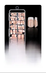 Detail of short square French nail tips in nude and white inside a clear storage box