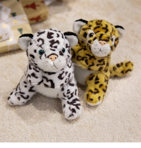 Close-up of leopard plush bracelets in white and yellow spots on a soft rug