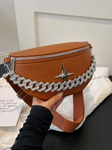 Brown lychee leather chest bag featuring a diamond-studded Cuban chain and star buckle