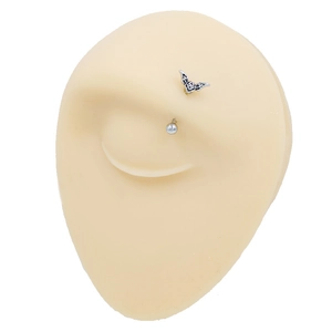 Bat and bead eyebrow rings in stainless steel shown on a silicone facial model