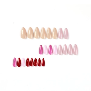 Glossy almond press-on nails set in nude, mauve, and deep red colors on white background