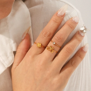18K gold plated stainless steel ring set with flower and bow zircon accents on model