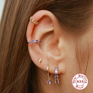 S925 sterling silver gold earrings set with purple zircon crystals on a female model