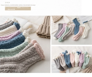 Close-up of thick coral fleece socks in pastel colors with cozy plush texture