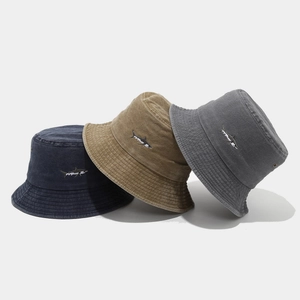 Three washed cotton bucket hats with shark embroidery in blue, khaki, and dark grey