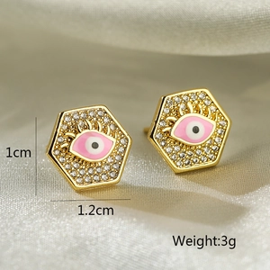 Macro detail of geometric hexagonal evil eye earrings with pink enamel and zircons