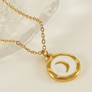 Golden moon pendant necklace with white enamel inlay and hammered metal texture frame