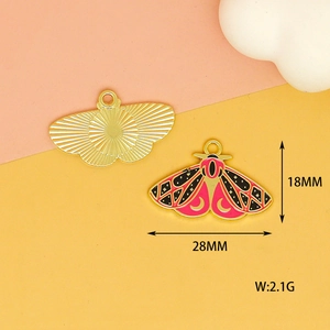Detail view of a 28x18mm pink butterfly enamel pendant with moon and star patterns