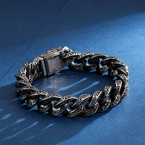 Macro shot of vintage floral carvings and 316L stainless steel hallmarks on men's bracelet